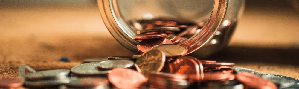 Coins spilling out of a jar