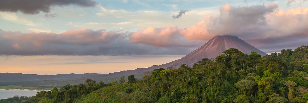 Arenal Volcano At Sunrise In Costa Rica, As The Sun Reflects On The Newly Formed Clouds