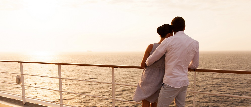 Young Couple Hugging At Sunset On Cruise Ship