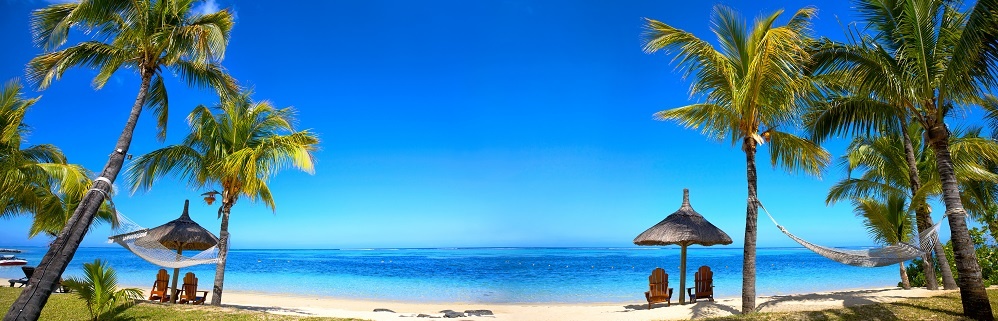 Tropical Beach Panorama With Chairs And Umbrellas