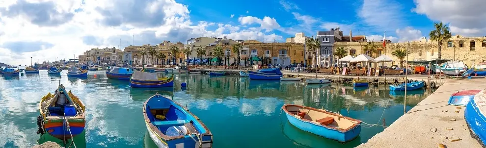 Marsaxlokk Fishermen Village In Malta. Panoramic View.