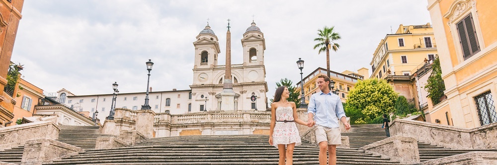Luxury Europe Travel Couple On Honeymoon Vacation Walking Down Spanish Steps Stairs In Rome, Italy. European Cruise Destination Italian Summer Holiday Tourists Reconnect