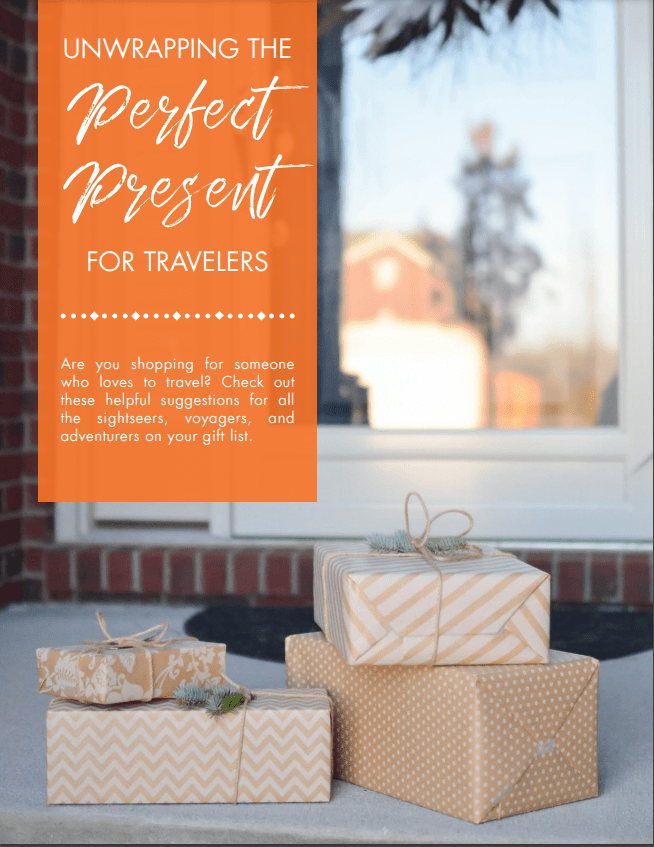 Gifts piled by a house's front door. Text reads: Unwrapping the Perfect Present for Travelers. Are you shopping for someone who loves to travel? Check out these helpful suggestions.