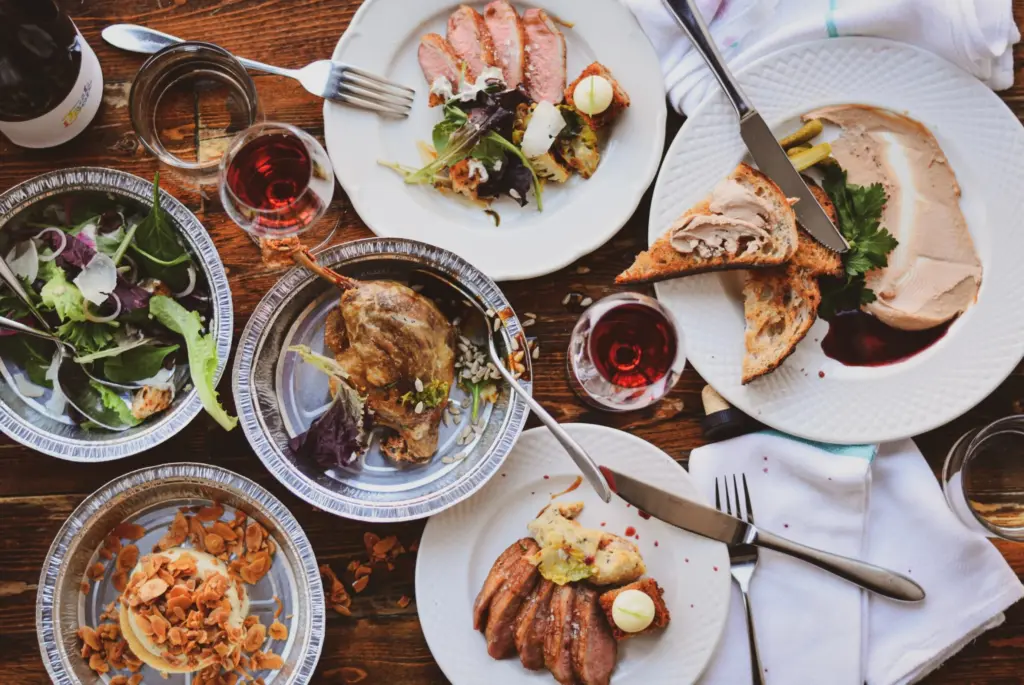 a variety of takout food in containers and on plates