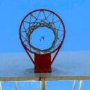 Airplane viewed through basketball hoop