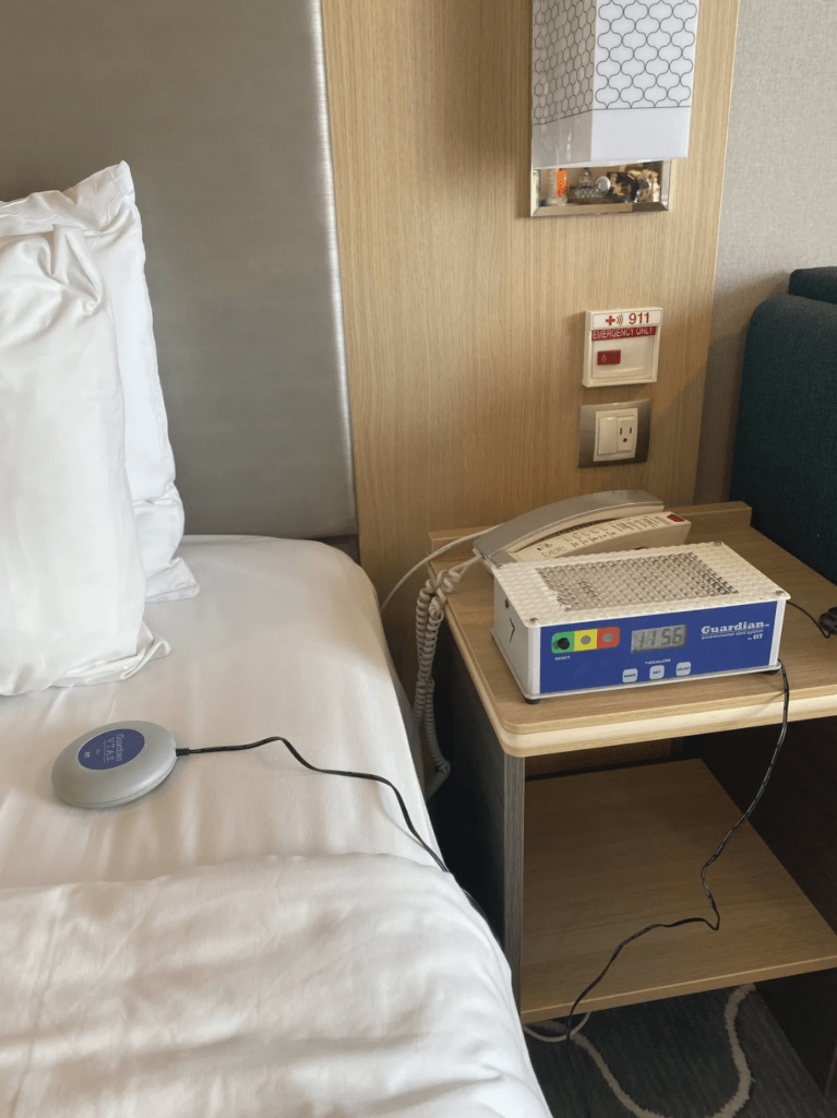 Portable hearing room kit on stateroom bedside table