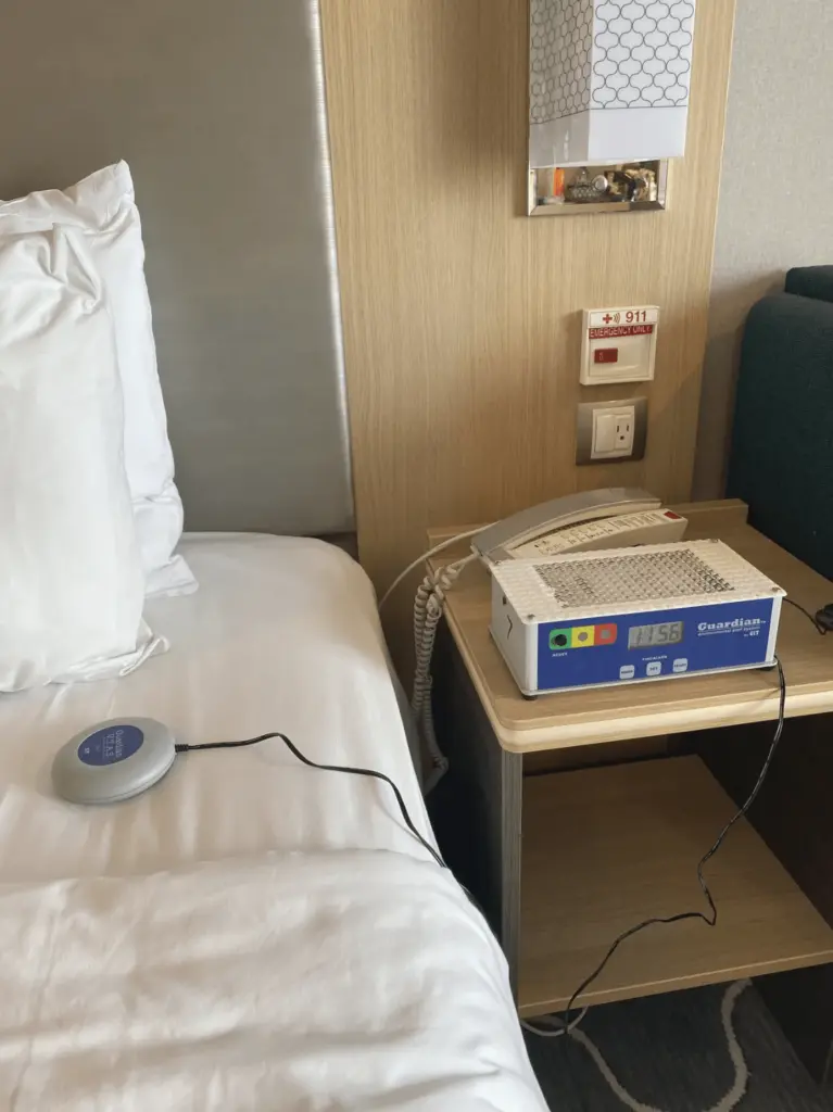 Portable hearing room kit on stateroom bedside table