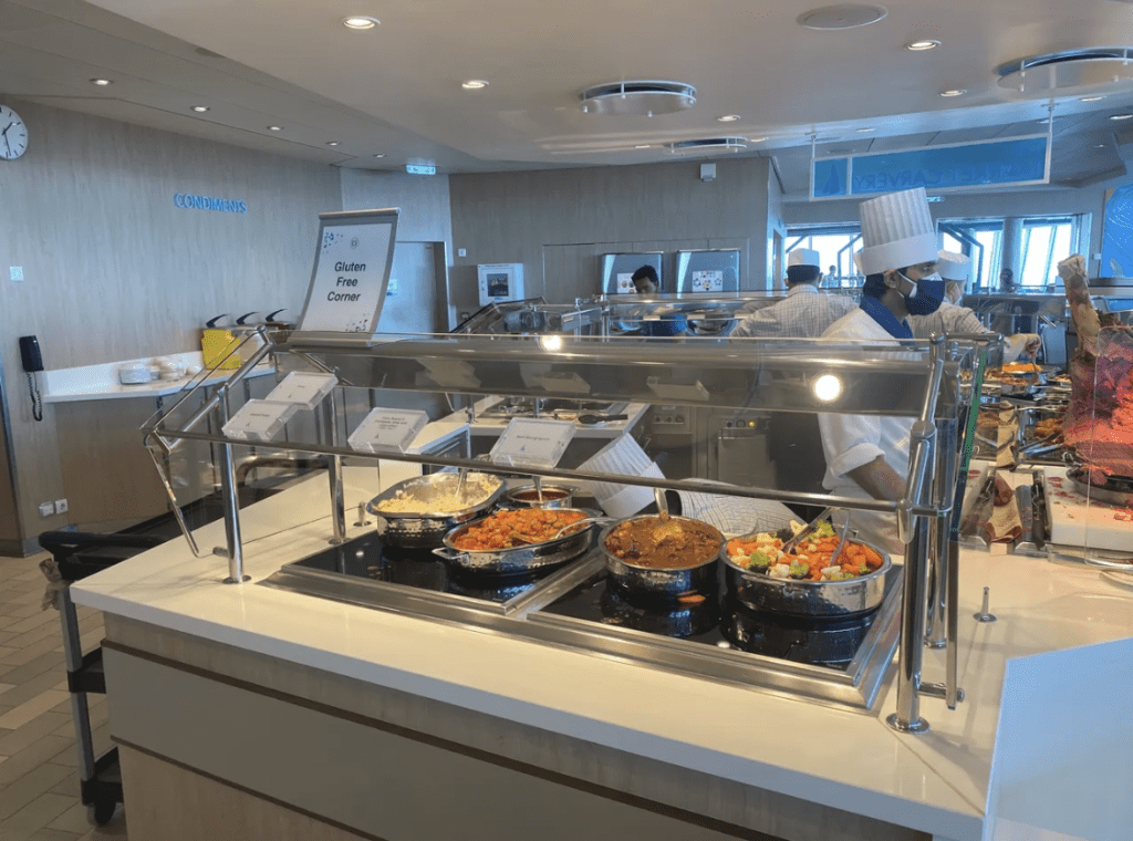 Food on a buffet with sign above that reads "Gluten Free Corner"