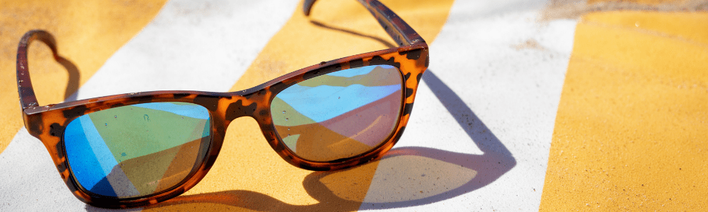 sunglasses towel on beach