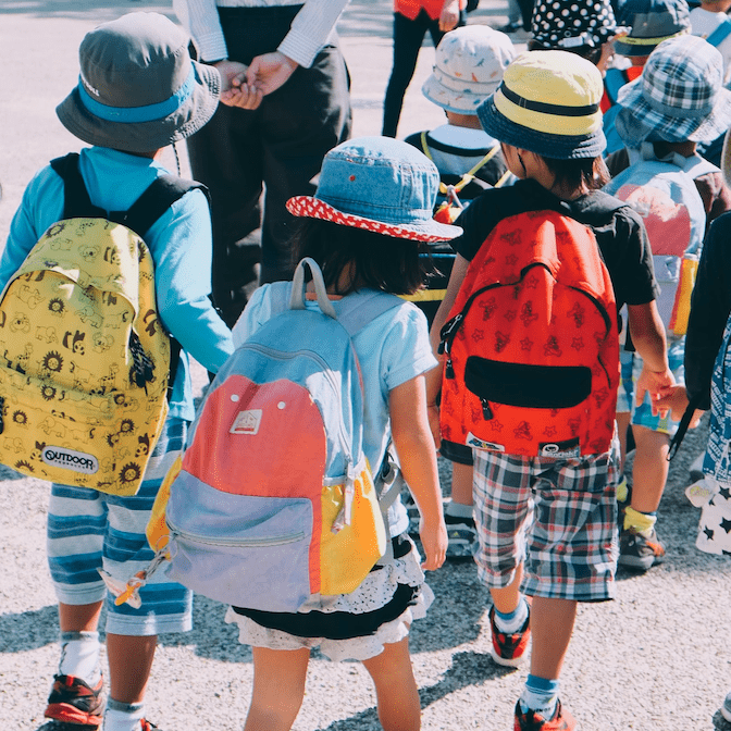 Children Walking With Backpacks