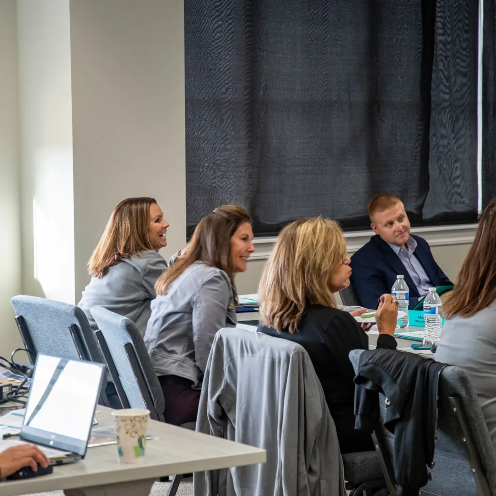 Group of travel agents sitting in a row listening to a presentation