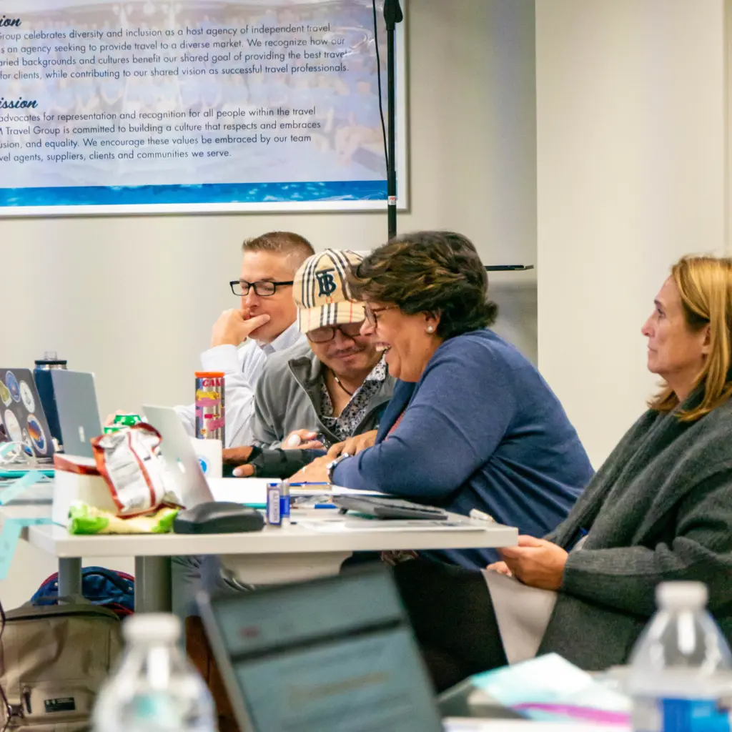 People with laptops in front of them smiling