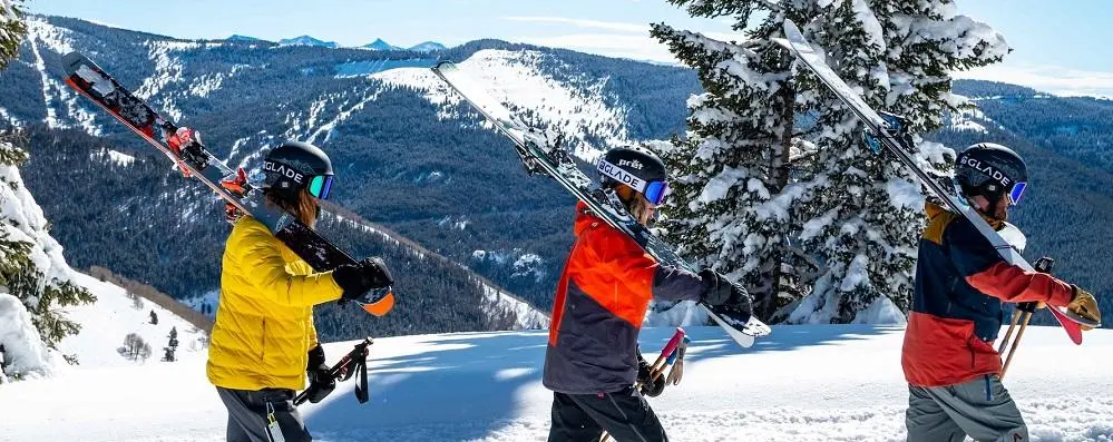 Three skiers walking along mountain ridge