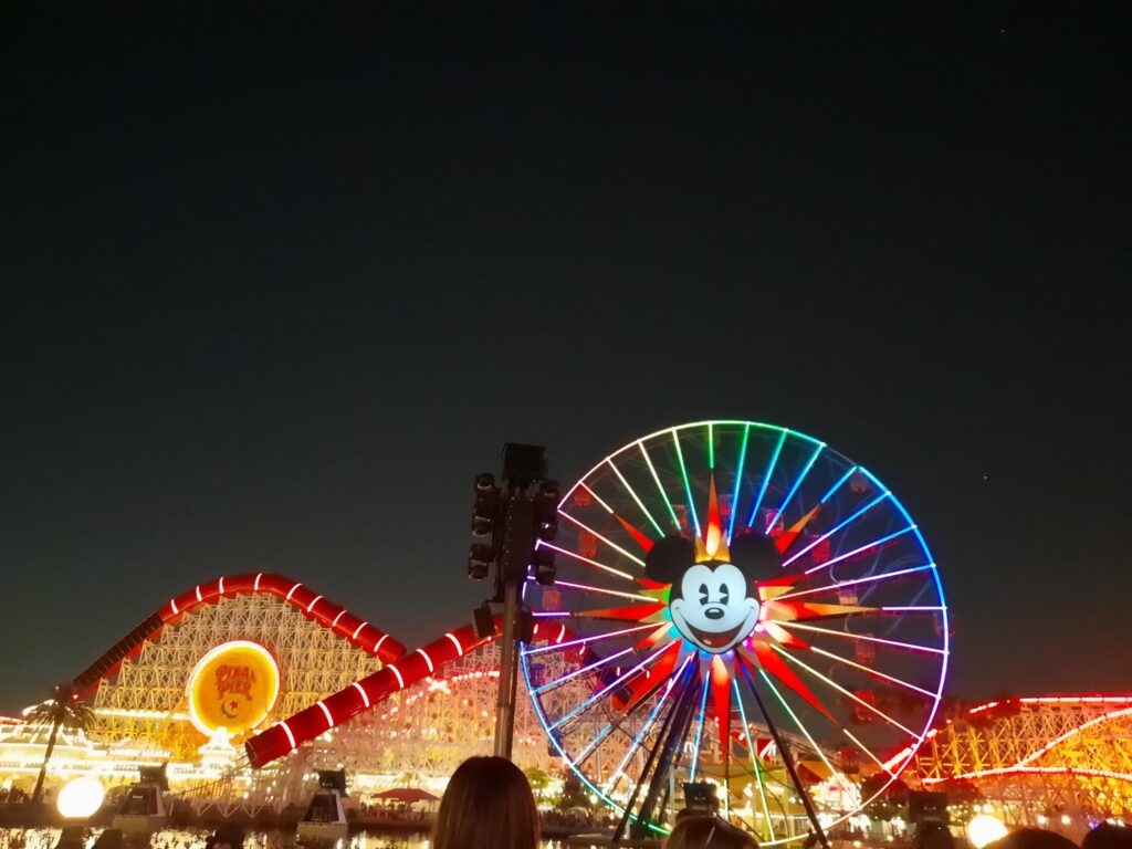 Pixar Pier and Mickey ferris wheel lit up in Disneyland at night